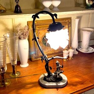 Brass lamp on marble base with flower light and fairy in a swing